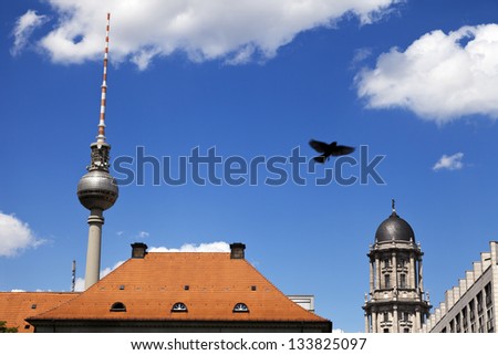 View at the world famous Berlin television tower rising behind buildings.
