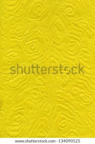 High resolution scan of yellow rice paper with a decorative pattern made of amorphic mandalas.