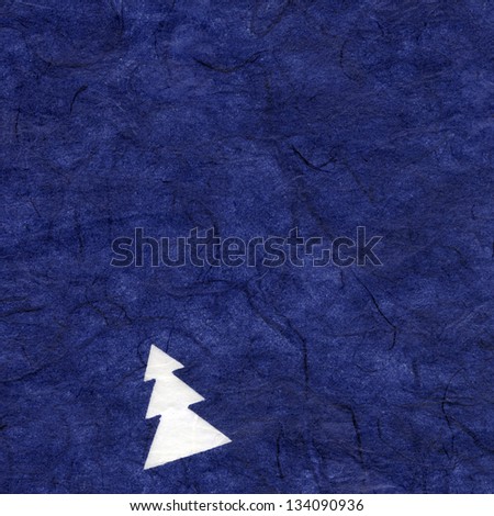 High resolution scan of blue rice paper with a pattern of white pine trees decorating its surface.