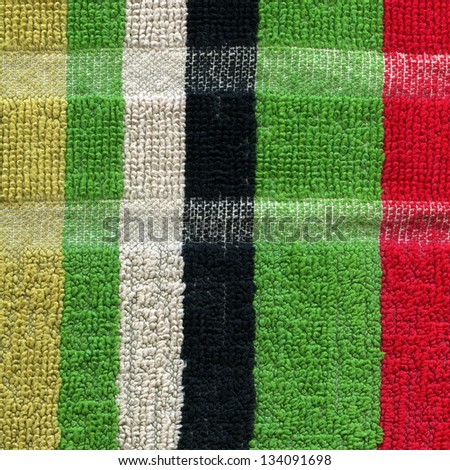High resolution close up of a colorful striped towel cloth with two lines crossing horizontally.