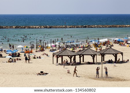 TEL AVIV - AUGUST 18: High angle view of the beach in Tel Aviv, packed with people on a hot summer day. On August 18, 2012, in Tel Aviv, Israel.