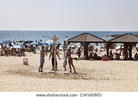 TEL AVIV - AUGUST 18: The beach in Tel-Aviv, packed with people on a hot summer day. On August 18, 2012, in Tel Aviv, Israel.