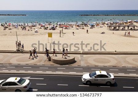TEL AVIV - AUG 18: High angle view of the beach in Tel-Aviv, packed with people on a hot summer day on August 18 2012 in Tel Aviv, Israel.
