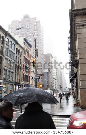 NEW YORK - NOV 7: Pedestrians rushing to cross the street in Chinatown, Manhattan, on a rainy day on November 7 2012 in New York, New York.
