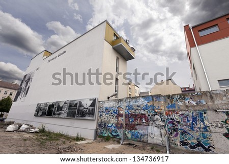 BERLIN - JUN 10: Graffiti covered remains of the Berlin wall, in Bernauer strasse. Photos depict the wall excerpt through the years on June 10 2012 in Berlin, Germany.