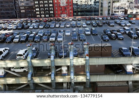 NEW YORK - NOV 6: The NYC Port Authority\'s rooftop parking lot, almost full with cars, and surrounded by midtown skyscrapers on November 6 2012 in New York, New York.