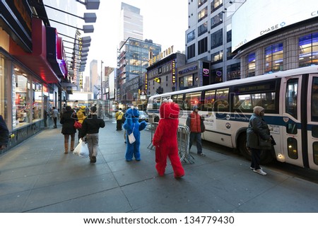 NEW YORK - NOV 6: Two actors hidden in Elmo and Cookie Monster costumes amuse the pedestrian walking by at 42nd street, just by Times Square in Manhattan  on November 6 2012 in New York, New York.