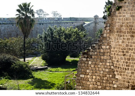 Morning time at the old town of Acco (Acre), Israel. At the front, the ruins of an internal wall; at the background, the surrounding wall which stood in defence from the city\'s enemies.