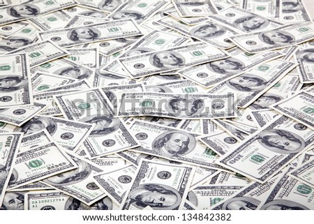 A high angle view of a very large amount of 100 US$ money notes in a bulky mess.