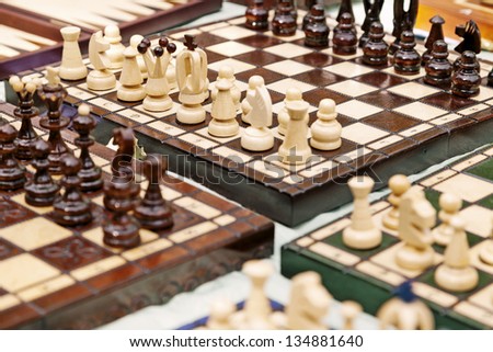 High angle view of a large amount of homemade chess boards displayed for sale on a table at a flea market.