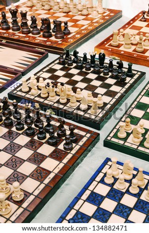 High angle view of a large amount of homemade chess boards displayed for sale on a table at the Mauerpark sunday flea market.