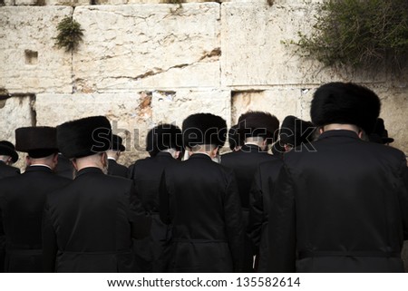 JERUSALEM - MAY 21: A group of orthodox Jewish young adult pressed in prayer against the wailing wall in the old city of Jerusalem on May 21 2010 in Jerusalem, Israel.