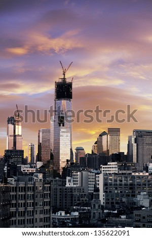 Sunset time on Lower Manhattan in a New-York Winter. One World Trade Center (aka Freedom Tower), in advanced state of construction,stands out of the skyscraper cluster.