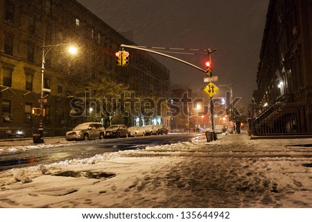 NEW YORK - NOV 7: The intersection of Manhattan Avenue and 122nd street in Harlem covered with snow with more of it coming from above, on November 7 2012 in New York, New York.
