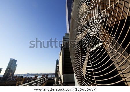 Wide Angle View At An Outdoor Hvac Air Conditioner Unit Located On A High-Floor Porch Of A Midtown Manhattan Skyscraper. The Hudson River Can Be Seen In The Background.