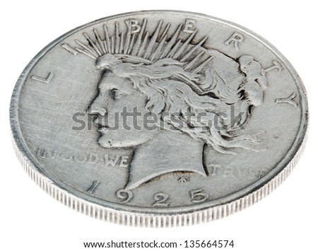 High angle view of the obverse (heads) of a silver dollar minted in 1925, known by the name \'Peace Dollar\'. Lady of liberty with a crown, recalls the statue of liberty. Isolated on white background.