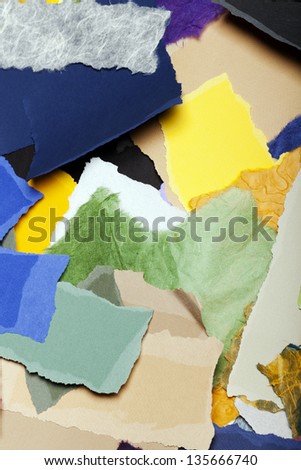Large group of torn pieces of paper in a large variety of colors.