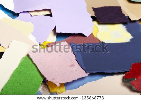 Large group of torn pieces of paper in a large variety of colors.