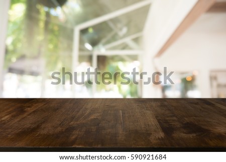 Wooden board empty table in front of blurred background. Perspective white house and  window - can be used for display or montage your products.Mock up for display of product.