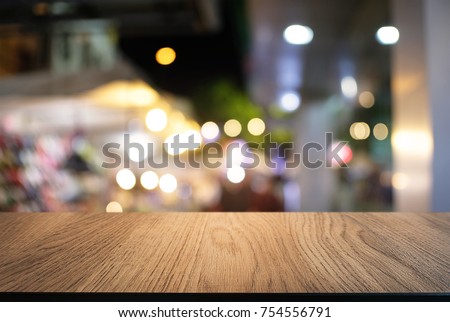 Empty wood table top and blur of night market background/selective focus .For montage product display