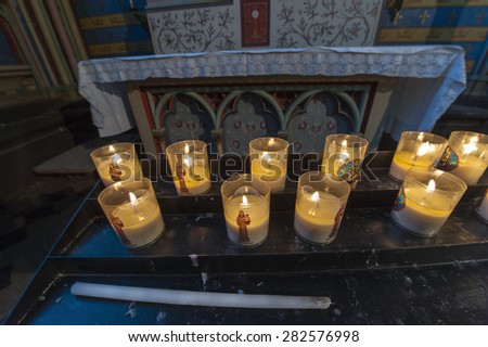 PARIS,FRANCE- CIRCA APRIL 2015: Burning candles in Notre Dame cathedral
