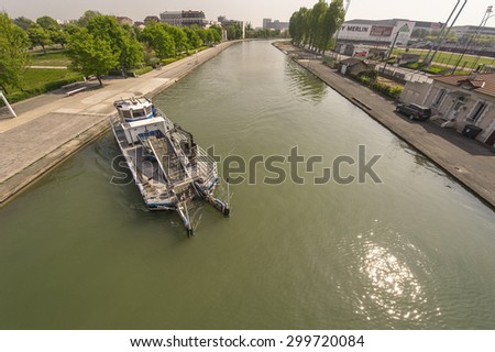 PARIS,FRANCE-CIRCA APRIL 2015: Waste cleaning boat on a channel at Saint Denis