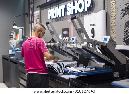 TURIN,ITALY-CIRCA SEPTEMBER 2015: Printing players\' names on the t-shirts in the official Juventus store