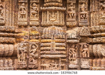 Ancient sandstone carvings on the walls of the ancient sun temple at Konark, India.