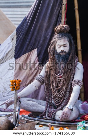 ALLAHABAD, INDIA - FEB 13 - An Hindu renunciate sits in meditation in front of his tent during the festival of Kumbha Mela on February 13th 2013 at Allahabad, India.