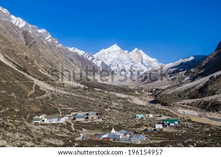 The settlement of Bhojbas in the Indian Himalayas with the Bhagirati peaks in the background.