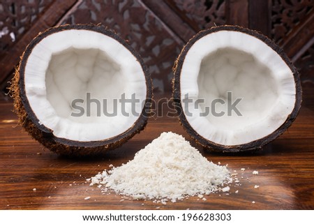 Coconut halves with shredded coconut in the foreground.