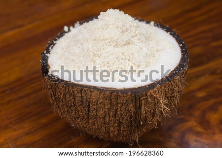 A half coconut filled with shredded coconut.