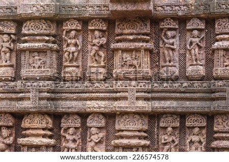 Ancient sandstone carvings on the walls of the ancient sun temple at Konark, India.