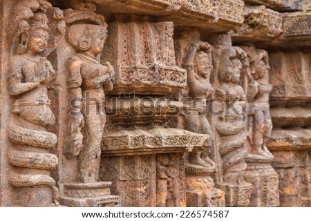 Ancient carvings of dancers and Nagas (half men, half snake deities) at the Sun Temple in Konark, India.