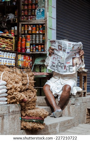 MYSORE, INDIA, JULY 24th A supplies shopkeeper reading the morning paper in Mysore, South India on 24th July 2010.