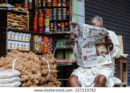 MYSORE, INDIA, JULY 24th A supplies shopkeeper reading the morning paper in Mysore, South India on 24th July 2010.