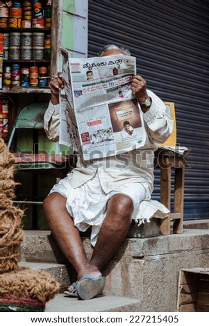 MYSORE, INDIA JULY 24th A shop keeper reading the morning newspaper in Mysore, South India on 24th July 2010.