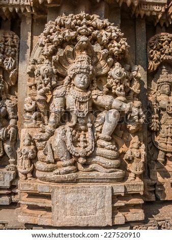 A carving of the Hindu god Vishnu sitting beneath a tree at the 13th Century temple of Somanathapur, Karnataka, South India.