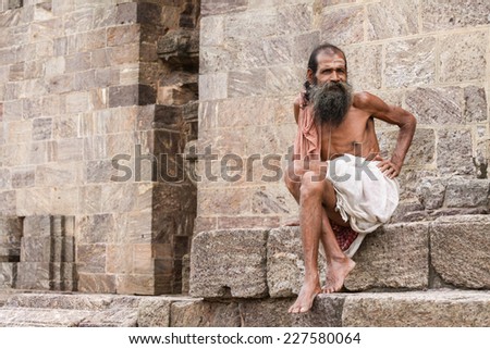 KONARK, INDIA OCT 8th 2010  An old man sitting on the steps of the Konark Temple in East India.