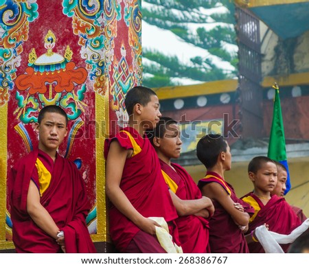 BOUDANATH, NEPAL - MAY 3: Tibetan monks wait stand in line during a Buddhist ritual.