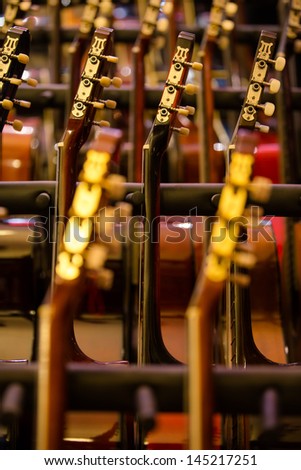 many guitars presented in a row - upright