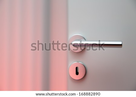 Aluminum door knob (door handle) on the white door
