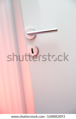 Aluminum door knob (door handle) on the white door