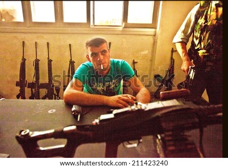 ATME, SYRIAN TURISH BORDER, 18 JUNE 2012:  Unidentified rebel of the Free Syrian Army pauses in the weaponry room at the Free Syrian Army headquarters.