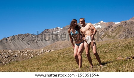 People in the mountains and sunbathe fooling around...