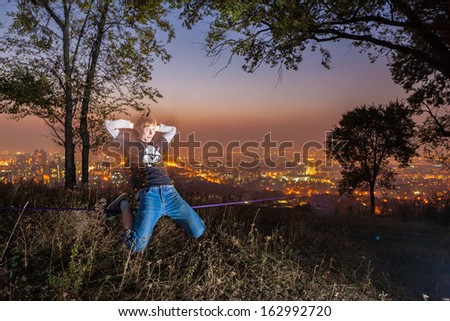 Man walking on a tightrope at sunset slack-line