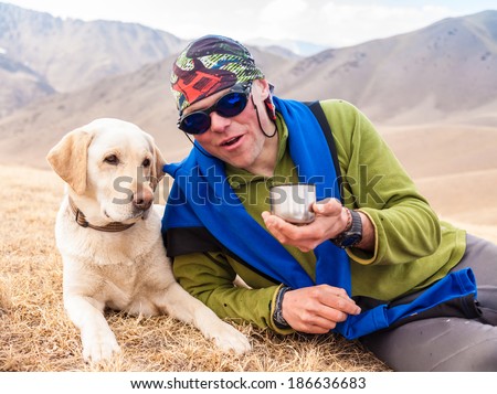 A man outdoors, walking in the mountains and enjoy the sights