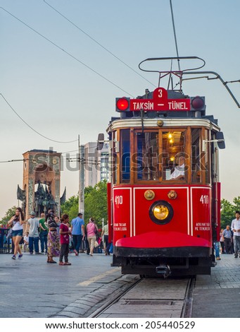 ISTANBUL, TURKEY - JULY 7: Red vintage tram on Taksim Square in Istanbul, Turkey. July 7, 2014 in Istanbul, Turkey. Taksim Republic Monument (Taksim Cumhuriyet An?t?) and the historic tram.