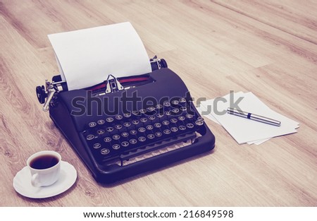Retro old typewriter with paper. Typewriter with coffee and paper notes.