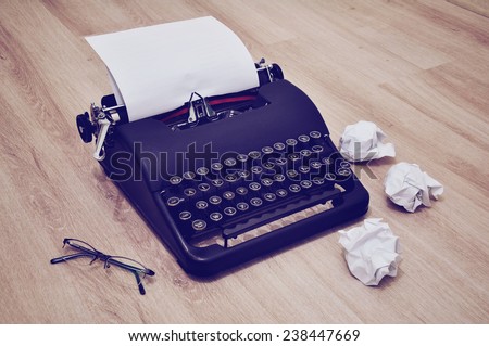 Retro old typewriter with paper. Typewriter with glasses and crumpled papers.